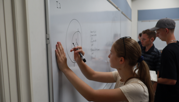 A student practicing at the board