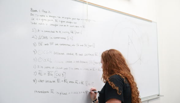 A student practices prop 2 at the board