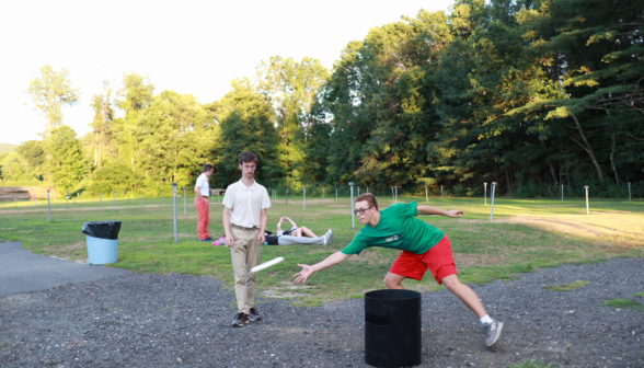 A student poised to catch a Frisbee