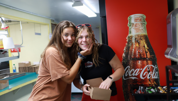 Two pose inside the snack shop