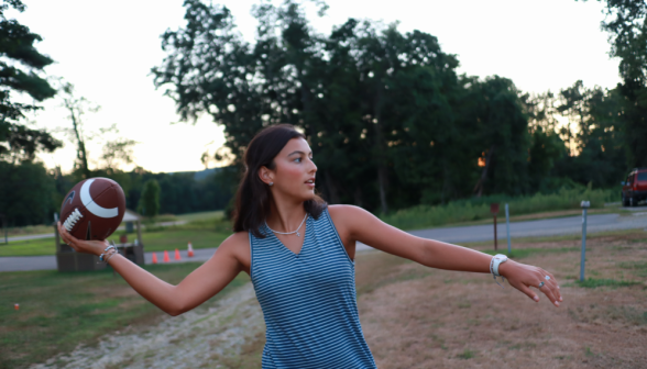 A student "wound up", about to throw the football long