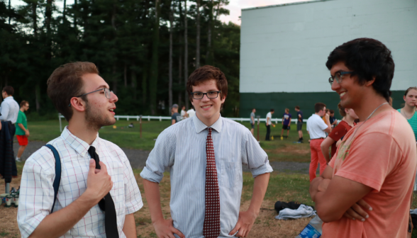 Two students in ties chat with a prefect