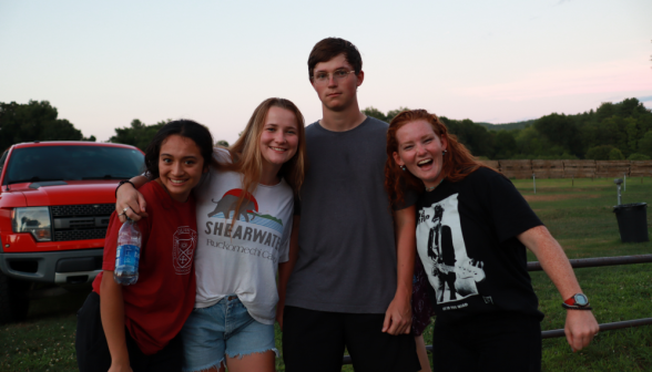 Three prefects pose with a programmer