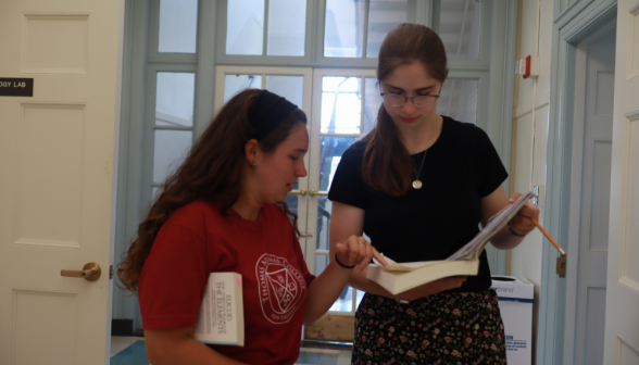 A prefect discusses a prop with a student