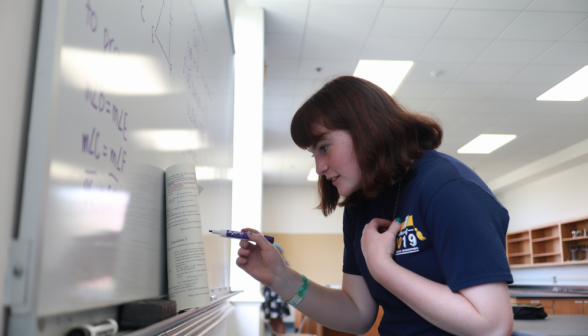 A student practices Euclid at the board