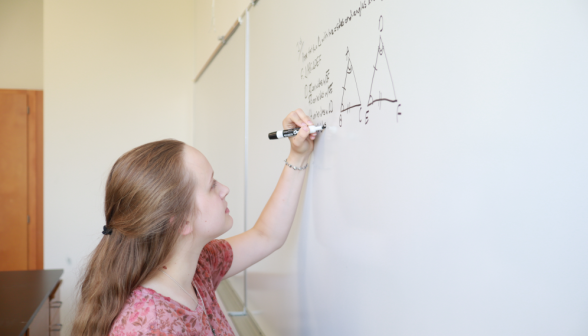 A student practices at the board