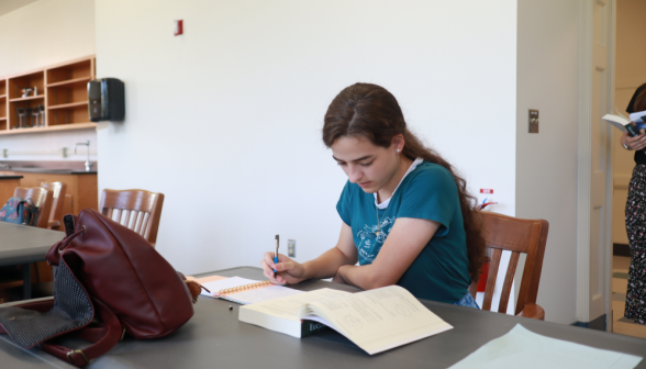 A student studies Euclid at the table