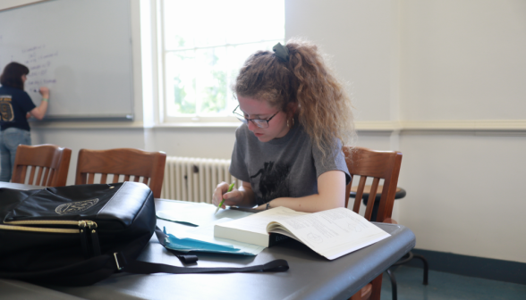 Another student studying at the table