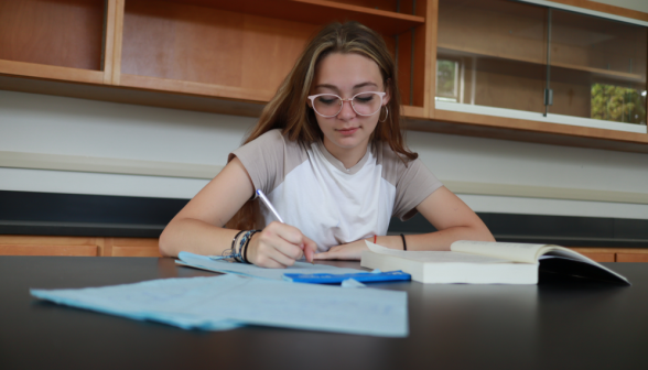 A student studies at one of the lab tables
