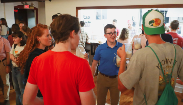 Students chat, drinks in hand