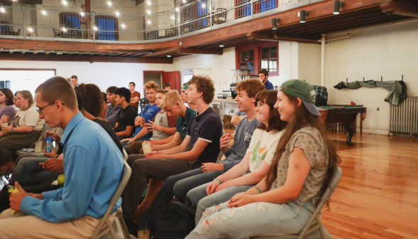 Students in chairs listen to the chaplains