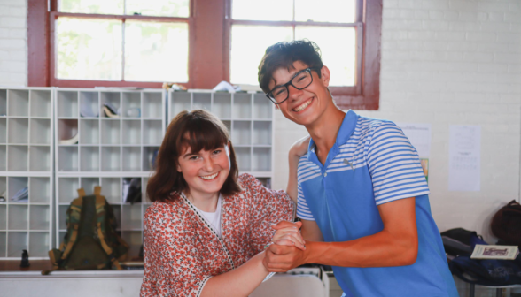 A student pair poses afront the mailboxes