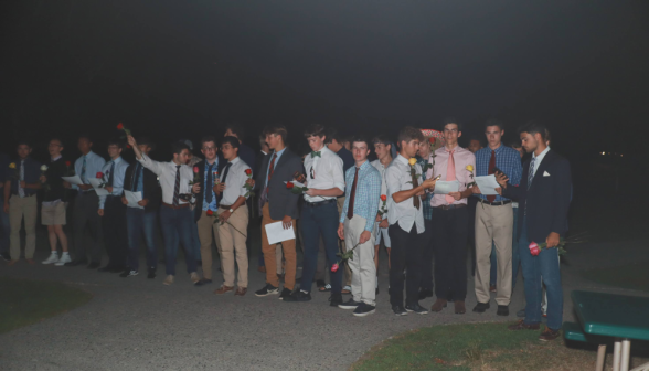 The men assemble outside the women's dorm