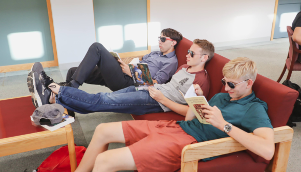Three cool men in shades study on a couch
