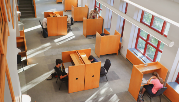 Students study at individual desks