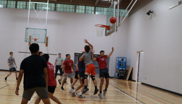 The shot misses, and chaos erupts as everyone pursues the rebound