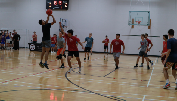 A student attempts a three-pointer