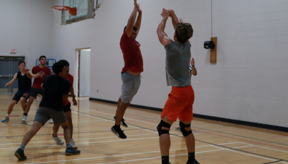 A prefect tries to block a student's shot