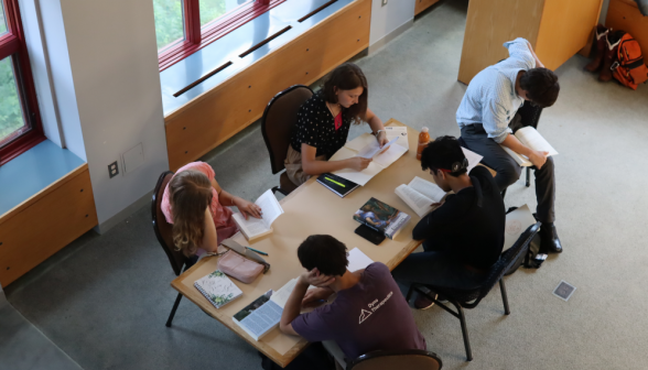 Five study at a rectangular table