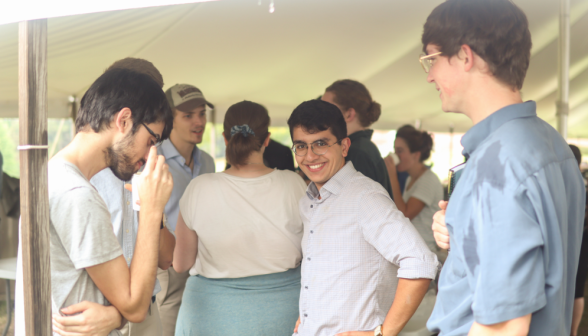 A student turns to smile at the camera