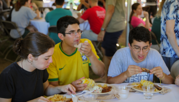 Three eating dinner