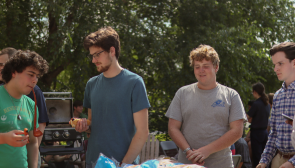 Four chatting by the barbecue