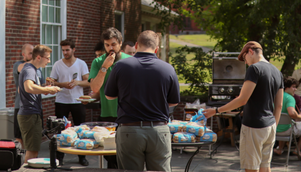 Students eat hotdogs