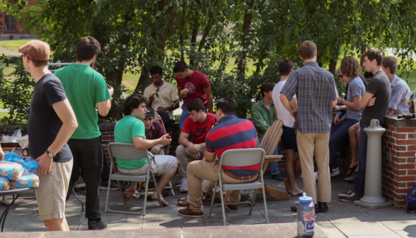 Students chat around the BBQ