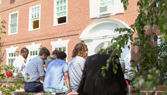 Students chat on the low wall