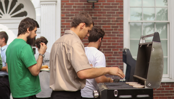 A student grills patties