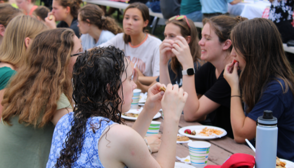 Close shot of students eating at the tables