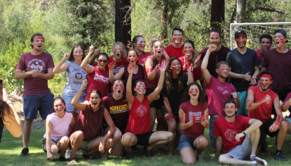 One of the teams poses, decorated in red paint