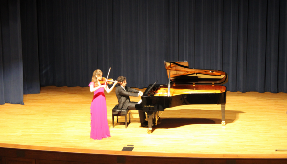 The duo performs on piano and violin