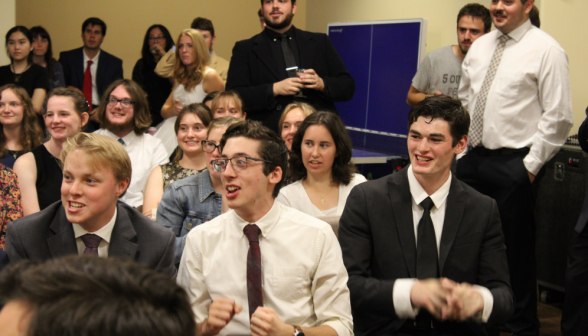 Excited students look on