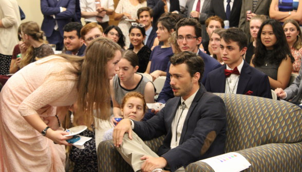 The student team leader confabulates with one of his team members