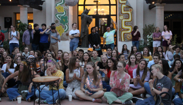 The students watch the skit and applaud