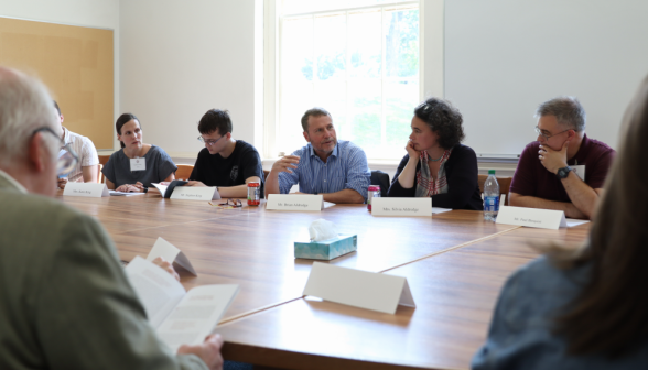Visitors discuss the Blue Book in a seminar led by President O'Reilly