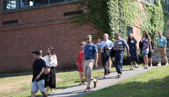 Visitors walk past Bolger on their campus tour