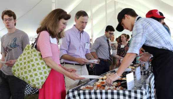 Everyone gets sandwiches at the food line