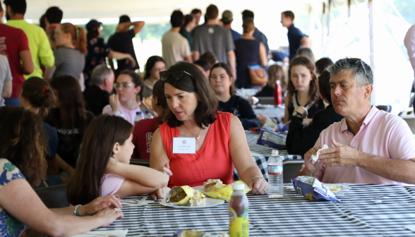 A family eats at one of the tables