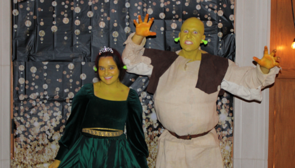 Two dressed and painted as Shrek and Princess Fiona