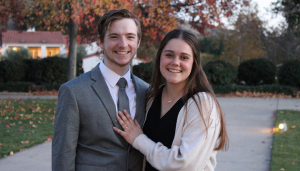 A student couple poses outside