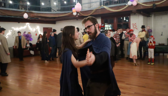 Two dressed as Aragorn and Arwen dance