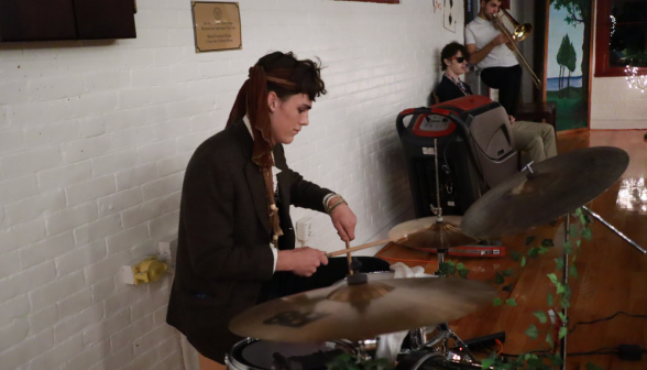 A student plays live music on the drums