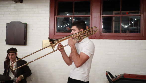 A student plays live music on the trombone