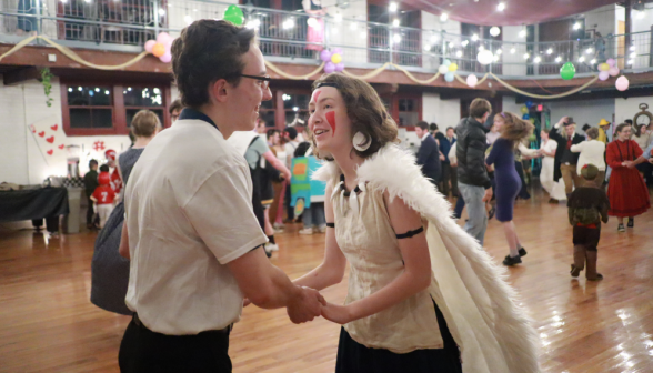 A student dances with another student dressed as Princess Mononoke