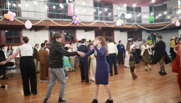 A student dances with another student dressed as Daphne from Scooby Doo