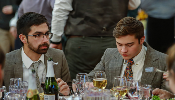 Two enjoy the dinner on one side of a table