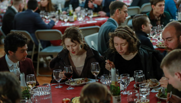 Students around one of the tables enjoy the meal