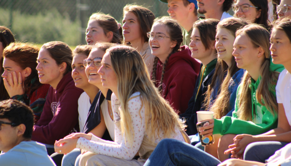 Students watch and cheer from the bleachers